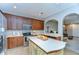 Spacious kitchen showcasing stainless steel appliances, wooden cabinetry, and an island with a white countertop at 12646 Carlby Cir, Tampa, FL 33626