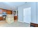 Stylish kitchen with stainless steel appliances, wood cabinetry, and an island with white countertops at 12646 Carlby Cir, Tampa, FL 33626