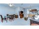 Open-concept living room featuring neutral toned walls, carpeted floors, and dining area with dark wood accents at 12646 Carlby Cir, Tampa, FL 33626
