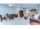 Bright living room with a dining area featuring carpeted floors, a ceiling fan, and neutral paint at 12646 Carlby Cir, Tampa, FL 33626