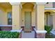 Front porch view featuring brick columns and a welcoming neutral-toned front door at 12646 Carlby Cir, Tampa, FL 33626