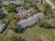 Aerial view highlighting the property's layout, landscaping, parking areas, and green spaces at 1333 Shady Pine Way # F, Tarpon Springs, FL 34688