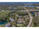 Aerial view of condo complex near East Lake High School with mature landscaping, ponds and community amenities at 1333 Shady Pine Way # F, Tarpon Springs, FL 34688
