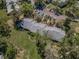 Drone shot showing the property's layout, parking, landscaping, and surrounding neighborhood at 1333 Shady Pine Way # F, Tarpon Springs, FL 34688