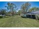 Expansive backyard with a well-maintained lawn, mature trees, and serene views at 1333 Shady Pine Way # F, Tarpon Springs, FL 34688