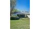 Well-maintained backyard with a screened patio, mature landscaping, and a tranquil setting at 1333 Shady Pine Way # F, Tarpon Springs, FL 34688