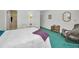 A comfortable bedroom with chairs, an octagonal mirror, and a rattan shelf at 1333 Shady Pine Way # F, Tarpon Springs, FL 34688