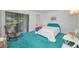 Bright bedroom with a queen bed, sliding glass door, and comfortable seating at 1333 Shady Pine Way # F, Tarpon Springs, FL 34688