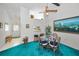 Open dining area with blue carpet, glass table, and easy access to the living room at 1333 Shady Pine Way # F, Tarpon Springs, FL 34688