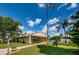 Beautiful exterior view featuring well-maintained landscaping, a community pool and an American flag under a sunny sky at 1333 Shady Pine Way # F, Tarpon Springs, FL 34688