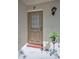 Inviting front door with decorative details and potted plant accent at 1333 Shady Pine Way # F, Tarpon Springs, FL 34688