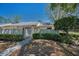 Landscaped front yard with pathway leading to inviting home entrance at 1333 Shady Pine Way # F, Tarpon Springs, FL 34688