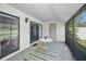 Relaxing lanai with screened windows, neutral walls, and a cozy seating area perfect for enjoying outdoor views at 1333 Shady Pine Way # F, Tarpon Springs, FL 34688