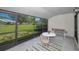 Screened lanai featuring seating and views of lush greenery perfect for enjoying peace and quiet at 1333 Shady Pine Way # F, Tarpon Springs, FL 34688