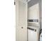 A stacked washer and dryer are behind a closed louvered door at 1333 Shady Pine Way # F, Tarpon Springs, FL 34688