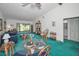 Bright living area with comfortable seating, a glass dining table, and a sliding glass door at 1333 Shady Pine Way # F, Tarpon Springs, FL 34688