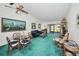 Cozy living room and dining area with a ceiling fan and sliding door to the outdoors at 1333 Shady Pine Way # F, Tarpon Springs, FL 34688