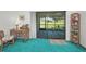 Cozy living room with a sliding glass door leading to the screened-in lanai, offering great views at 1333 Shady Pine Way # F, Tarpon Springs, FL 34688