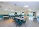 Spacious meeting room with long tables, chairs, and views of the surrounding community through large windows at 1333 Shady Pine Way # F, Tarpon Springs, FL 34688