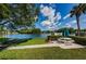 Community picnic area featuring picnic table, grassy space, and views of the lake at 1333 Shady Pine Way # F, Tarpon Springs, FL 34688