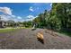 Open playground with slide, seesaw, and spring rider surrounded by green space in the community at 1333 Shady Pine Way # F, Tarpon Springs, FL 34688