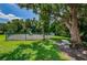 Community playground surrounded by lush greenery, featuring a park bench and play equipment at 1333 Shady Pine Way # F, Tarpon Springs, FL 34688