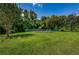 Community playground with lush greenery and shade trees on a sunny day at 1333 Shady Pine Way # F, Tarpon Springs, FL 34688