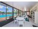 Bright pool area with seating and a view of the outdoor pool through large, sunlit windows at 1333 Shady Pine Way # F, Tarpon Springs, FL 34688