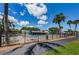 Community pool area featuring lounge chairs, mature trees, and lush landscaping at 1333 Shady Pine Way # F, Tarpon Springs, FL 34688