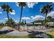 Community pool area featuring lounge chairs, mature trees, and lush landscaping at 1333 Shady Pine Way # F, Tarpon Springs, FL 34688