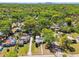 An aerial view of the neighborhood shows homes surrounded by lush greenery, offering a peaceful and private setting at 1401 E North St, Tampa, FL 33604