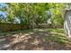 Backyard featuring a privacy fence and mature shade trees at 1401 E North St, Tampa, FL 33604