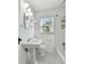 Classic bathroom with a pedestal sink, tiled floors, and a tub with a shower at 1401 E North St, Tampa, FL 33604