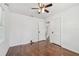 Bright bedroom featuring hardwood floors, a ceiling fan, and white trim at 1401 E North St, Tampa, FL 33604