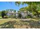 Charming single-story home with a lush green yard and mature trees at 1401 E North St, Tampa, FL 33604