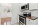 Charming kitchen with white cabinets, stainless steel appliances, and natural lighting at 1401 E North St, Tampa, FL 33604