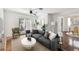 Cozy living room featuring a ceiling fan, a comfortable sofa, and access to the patio at 1401 E North St, Tampa, FL 33604