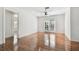 Bright living room featuring hardwood floors, white walls, and French doors to the backyard at 1401 E North St, Tampa, FL 33604