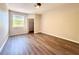 Bright bedroom featuring modern ceiling fan, a large window and wood-look floors at 17114 Carrington Park Dr # 207, Tampa, FL 33647