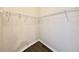 Walk-in closet with neutral walls, built-in shelving, and wood-look floors at 17114 Carrington Park Dr # 207, Tampa, FL 33647