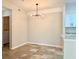 Open Dining Room with modern chandelier, neutral paint and tile flooring, with laundry room access visible at 17114 Carrington Park Dr # 207, Tampa, FL 33647