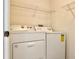 Laundry room with shelving and side-by-side Whirlpool washer and dryer at 17114 Carrington Park Dr # 207, Tampa, FL 33647
