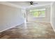 Bright and airy living room featuring neutral paint, tile flooring, decorative crown moulding, and large windows with views at 17114 Carrington Park Dr # 207, Tampa, FL 33647