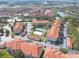 Aerial view of the expansive condo complex with a tennis court and nearby lake at 18001 Richmond Place Dr # 1032, Tampa, FL 33647