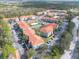 Aerial view of the condo complex including tennis courts and surrounding tree coverage at 18001 Richmond Place Dr # 1032, Tampa, FL 33647