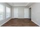 Spacious bedroom features two windows, dark wood floors, and neutral paint at 18001 Richmond Place Dr # 1032, Tampa, FL 33647
