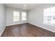 Bright bedroom with hardwood floors and two windows that allow for ample natural light at 18001 Richmond Place Dr # 1032, Tampa, FL 33647