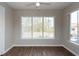 Sunlit bedroom with windows offering ample natural light and hardwood floors at 18001 Richmond Place Dr # 1032, Tampa, FL 33647