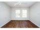 Bright bedroom with hardwood floors and two windows that allow for ample natural light at 18001 Richmond Place Dr # 1032, Tampa, FL 33647