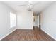 Bright bedroom with hardwood floors, white walls, and access to bathroom at 18001 Richmond Place Dr # 1032, Tampa, FL 33647